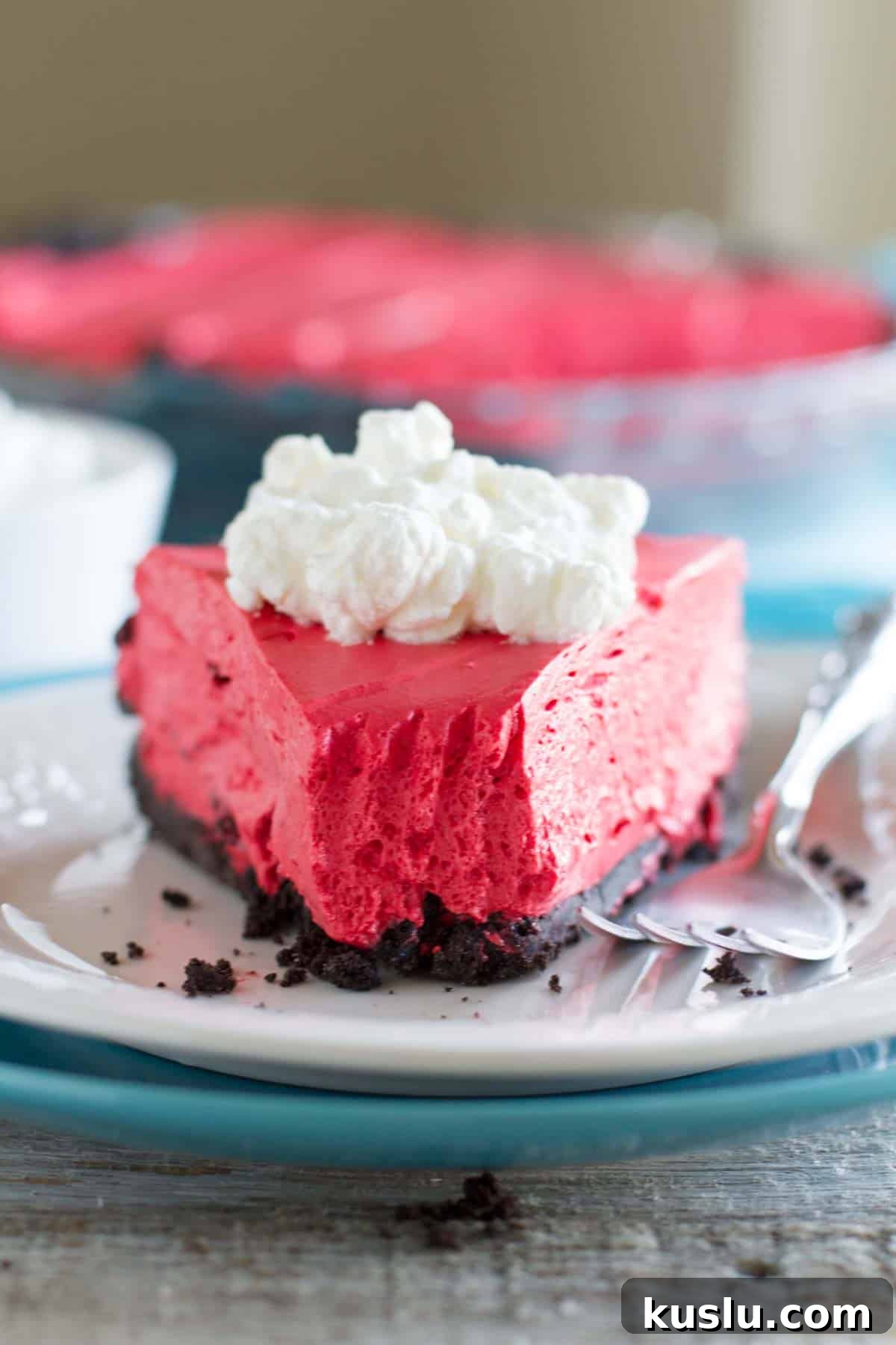 Slice of no bake red velvet cheesecake with a bite taken from it.