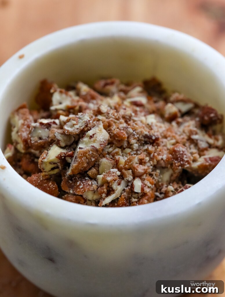 Classic Pineapple Upside-Down Cake Recipe with Caramelized Pineapple 7 chopped praline pecans in white marble bowl