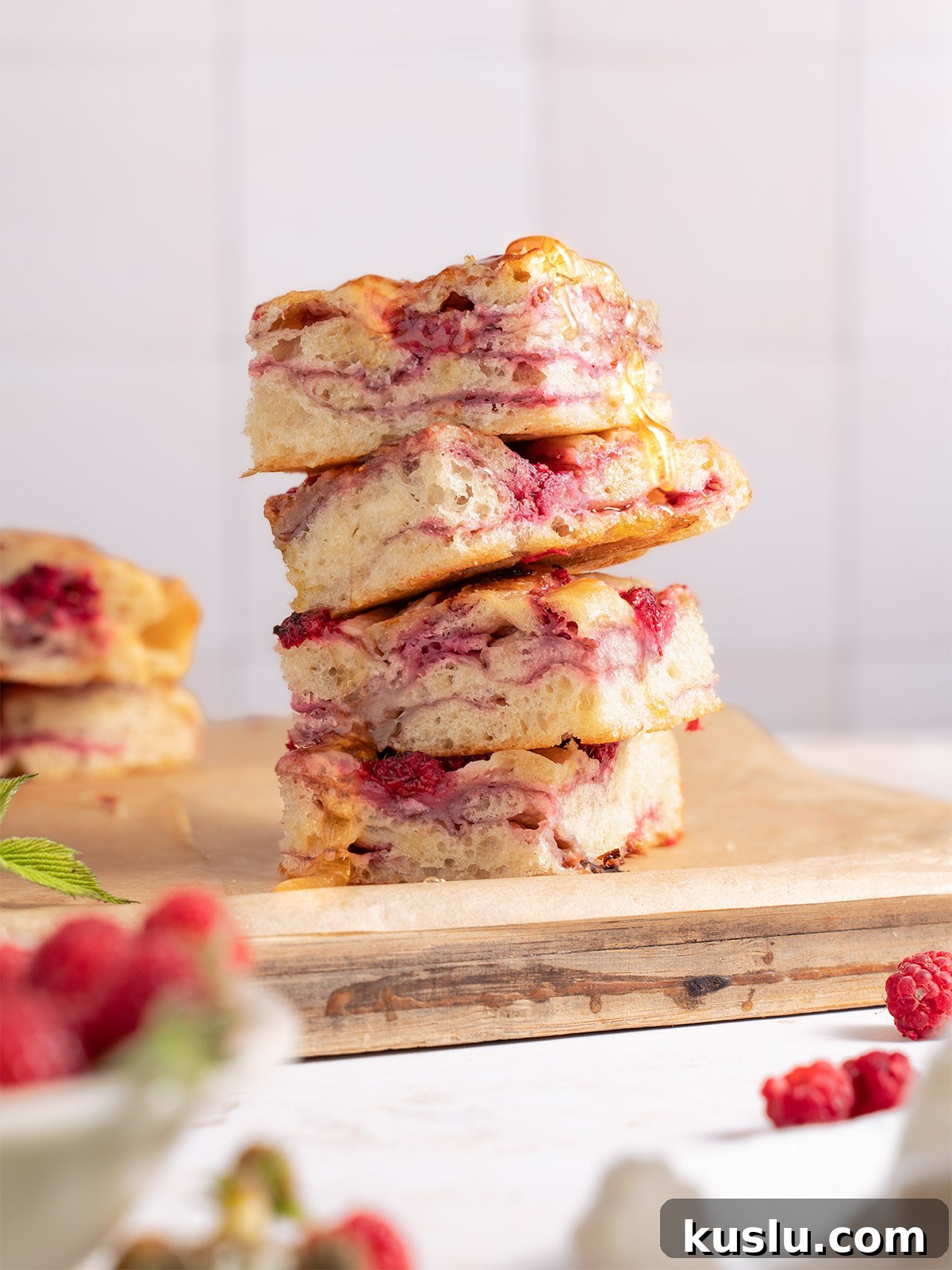 Squares of raspberry brie focaccia bread stacked on top of each other