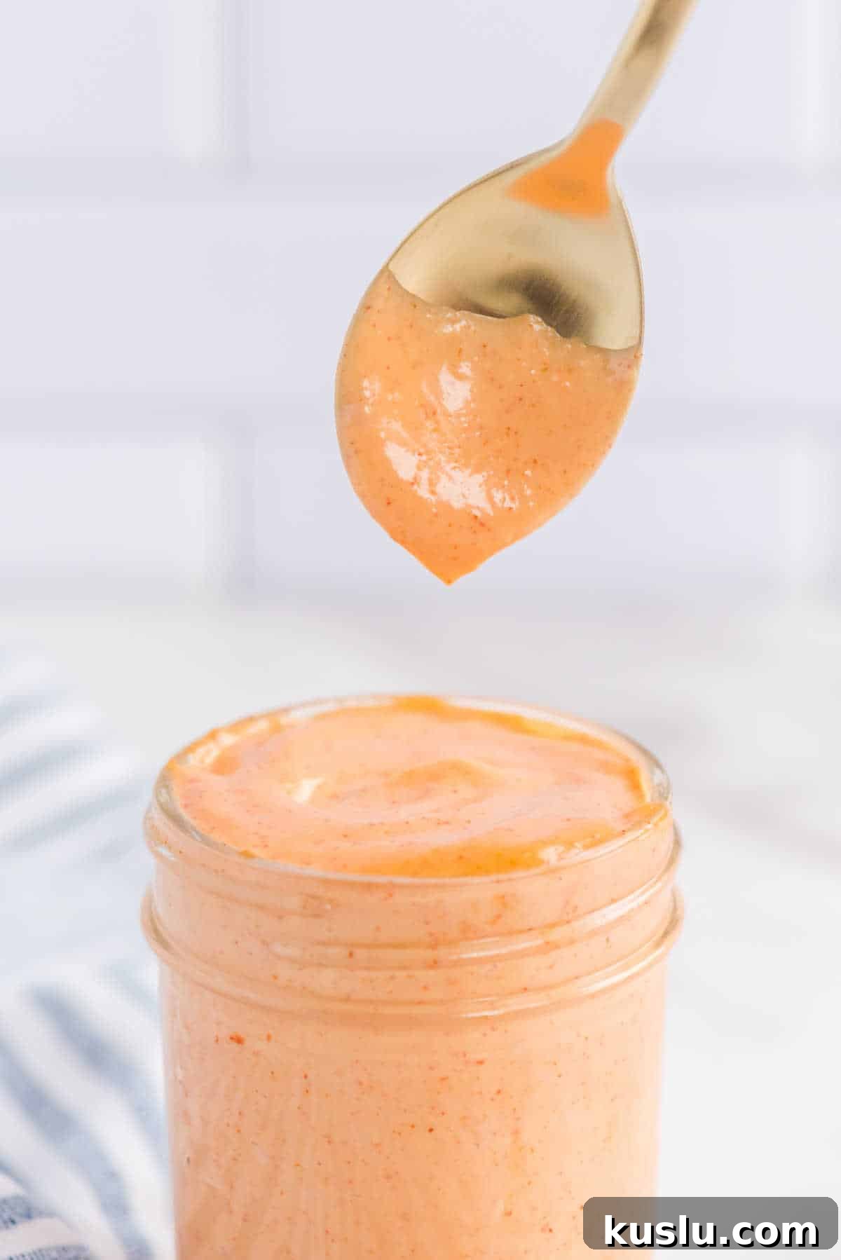 How to Make Yum Yum Sauce at Home: Simple Japanese Steakhouse Recipe 6 Yum Yum Sauce in a jar with a spoon over top.