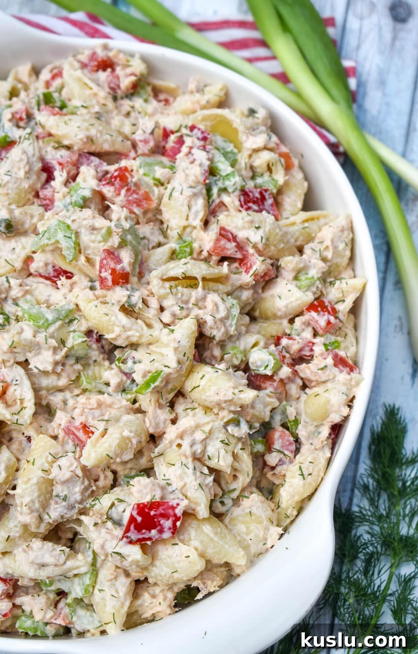 canned salmon pasta salad in a large white serving bowl