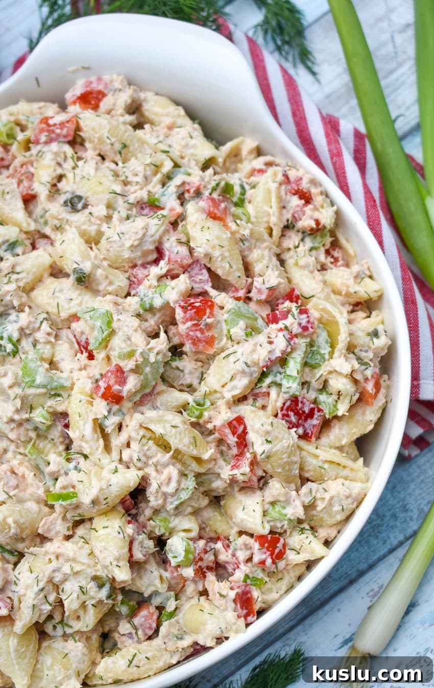 canned salmon pasta salad in a large white serving bowl