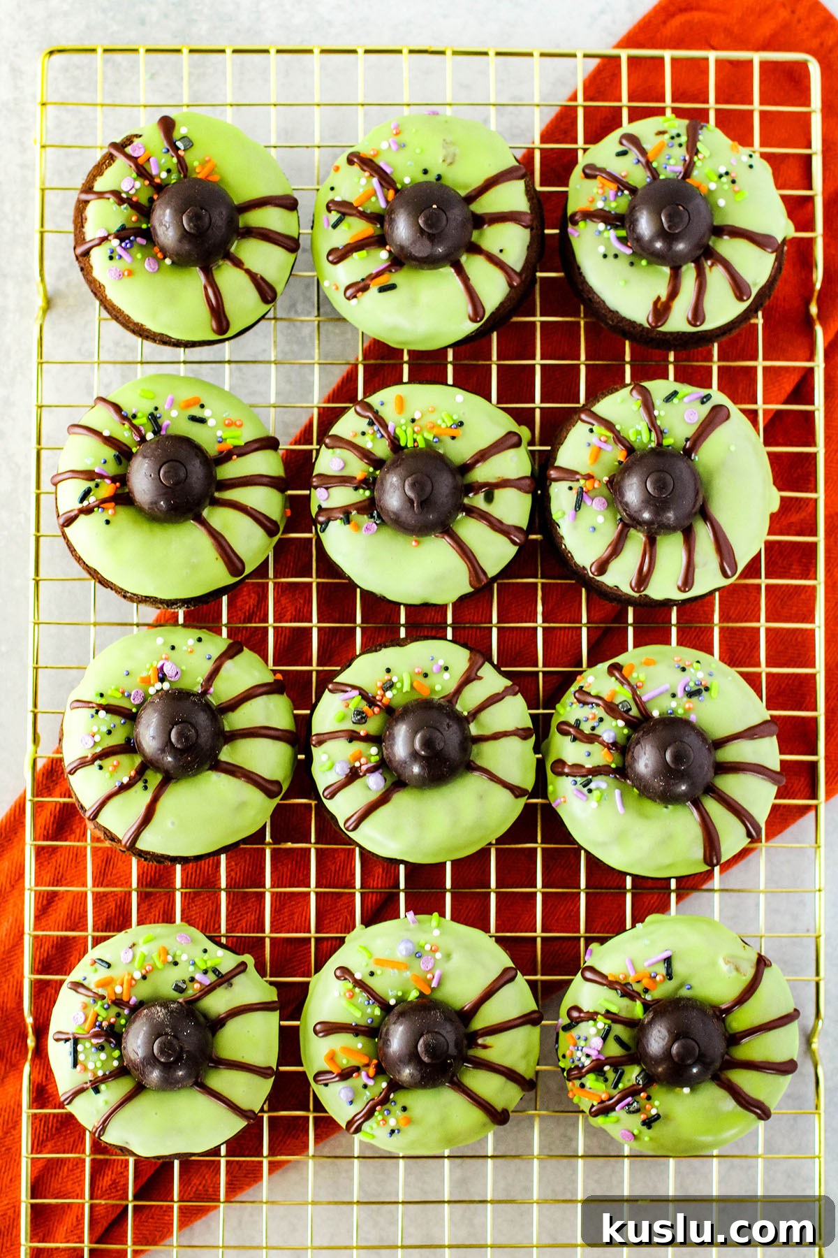 Spider Donuts Guide: How to Make Creepy Halloween Donuts 11 Decorated Spider donuts on a wire rack.