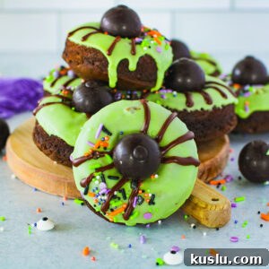 Spider Donuts Guide: How to Make Creepy Halloween Donuts 13 Spider Donuts with green icing on a round serving board.