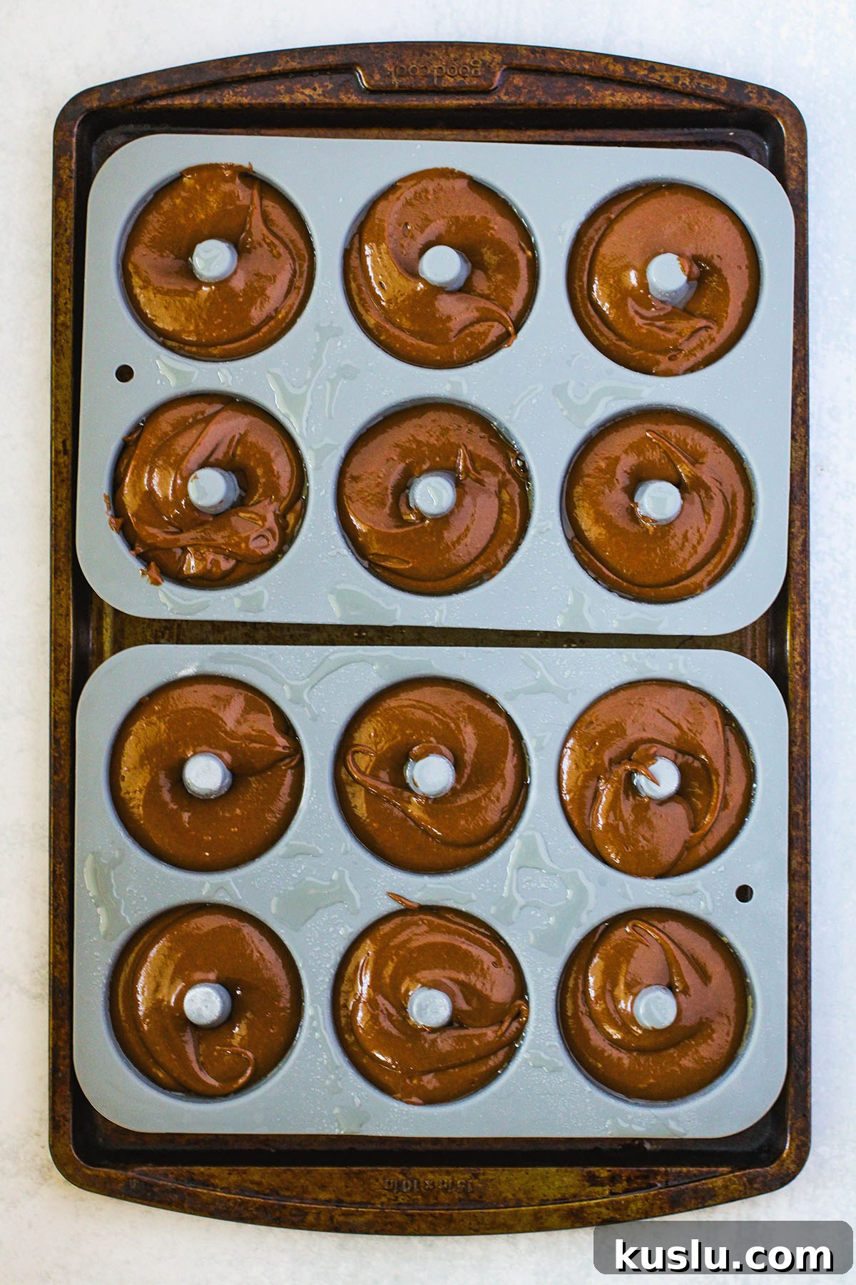 Spider Donuts Guide: How to Make Creepy Halloween Donuts 7 Chocolate donut batter is poured into a donut pan.