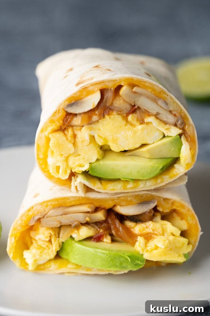 Vegetarian Breakfast Burrito with Fresh Salsa Recipe 2 Two halves of a meatless breakfast burrito stacked on top of each other.