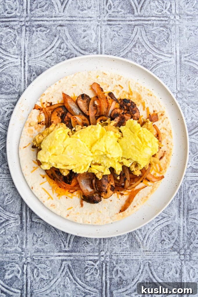 Vegetarian Breakfast Burrito with Fresh Salsa Recipe 8 Adding scrambled egg to vegetarian breakfast burrito.