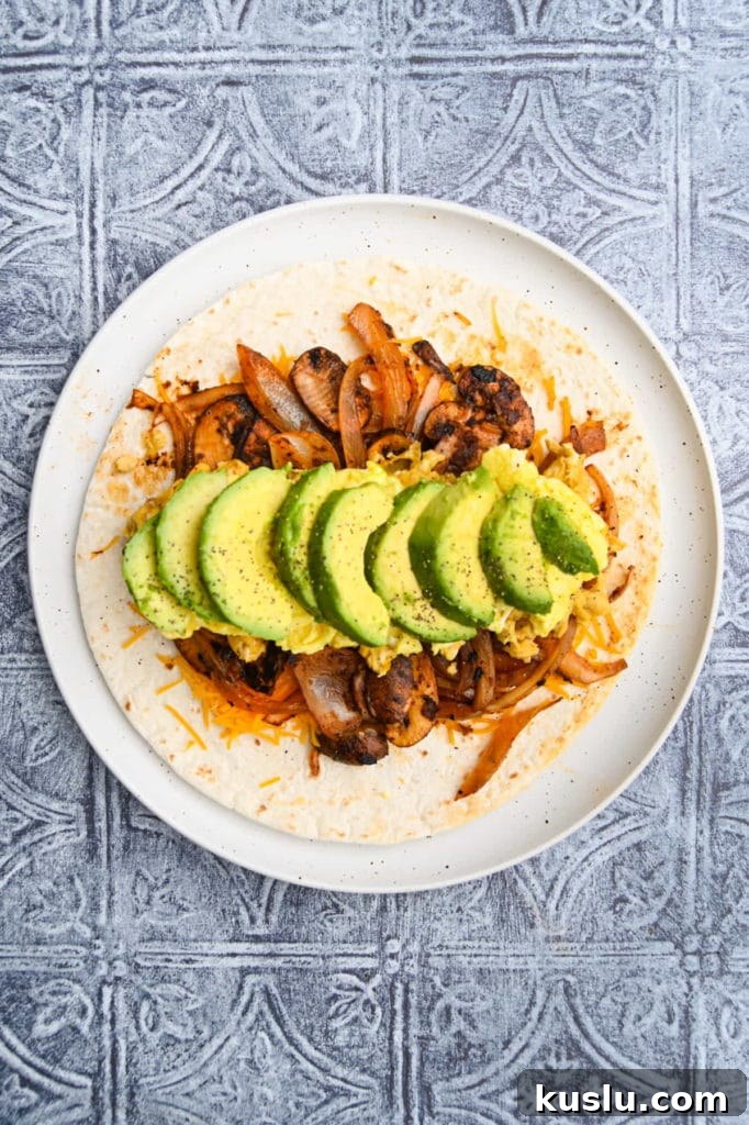 Vegetarian Breakfast Burrito with Fresh Salsa Recipe 9 Adding sliced avocado to vegetarian breakfast burrito.