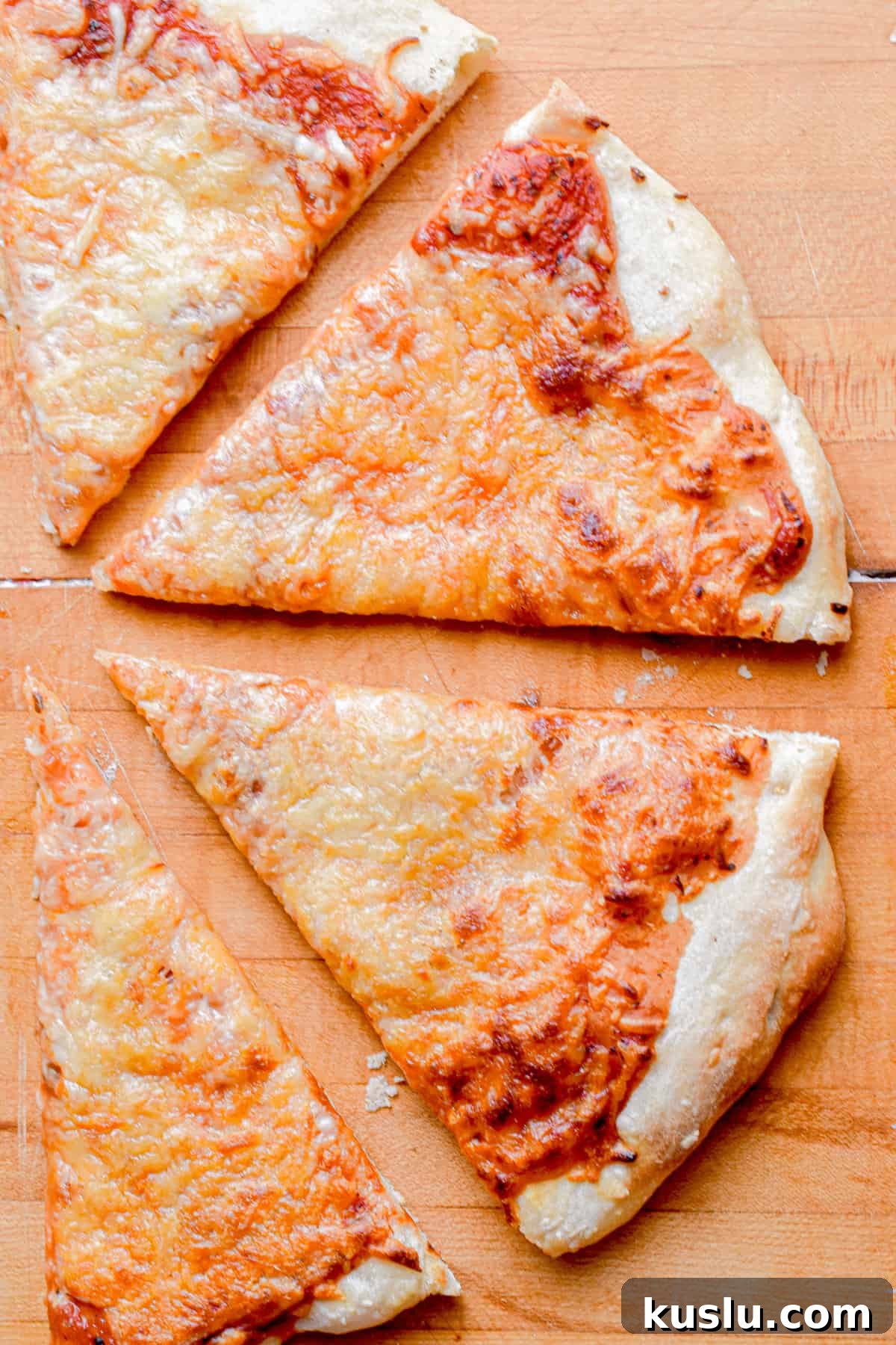 Sourdough Cast-Iron Pizza Without Yeast: Crispy Homemade Pie 12 Four triangle slices of pizza are lined up forming a half circle.