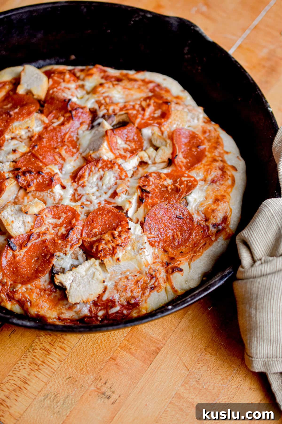 Sourdough Cast-Iron Pizza Without Yeast: Crispy Homemade Pie 13 The sourdough pizza is in a cast iron skillet.