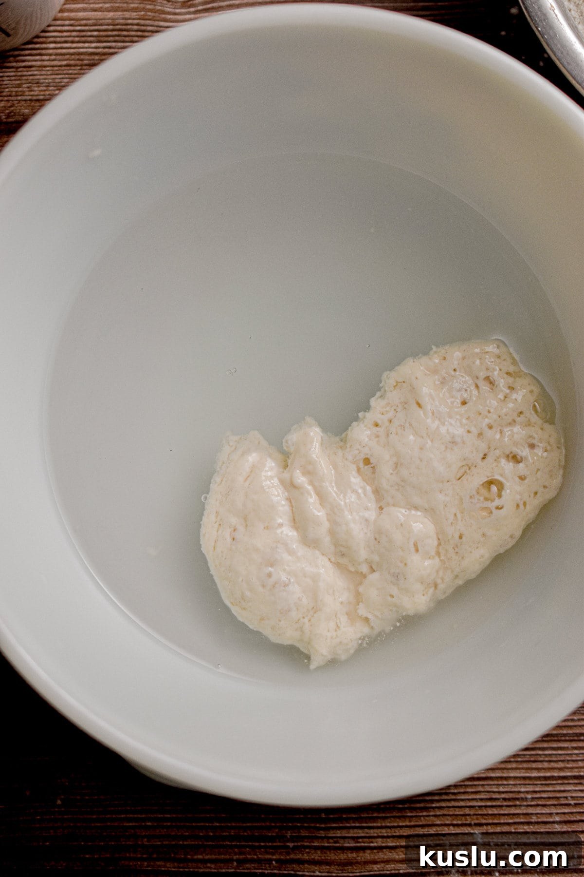 Sourdough Cast-Iron Pizza Without Yeast: Crispy Homemade Pie 4 The float test is being shown in a bowl.