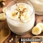 Banana ice cream in a glass on a wooden board