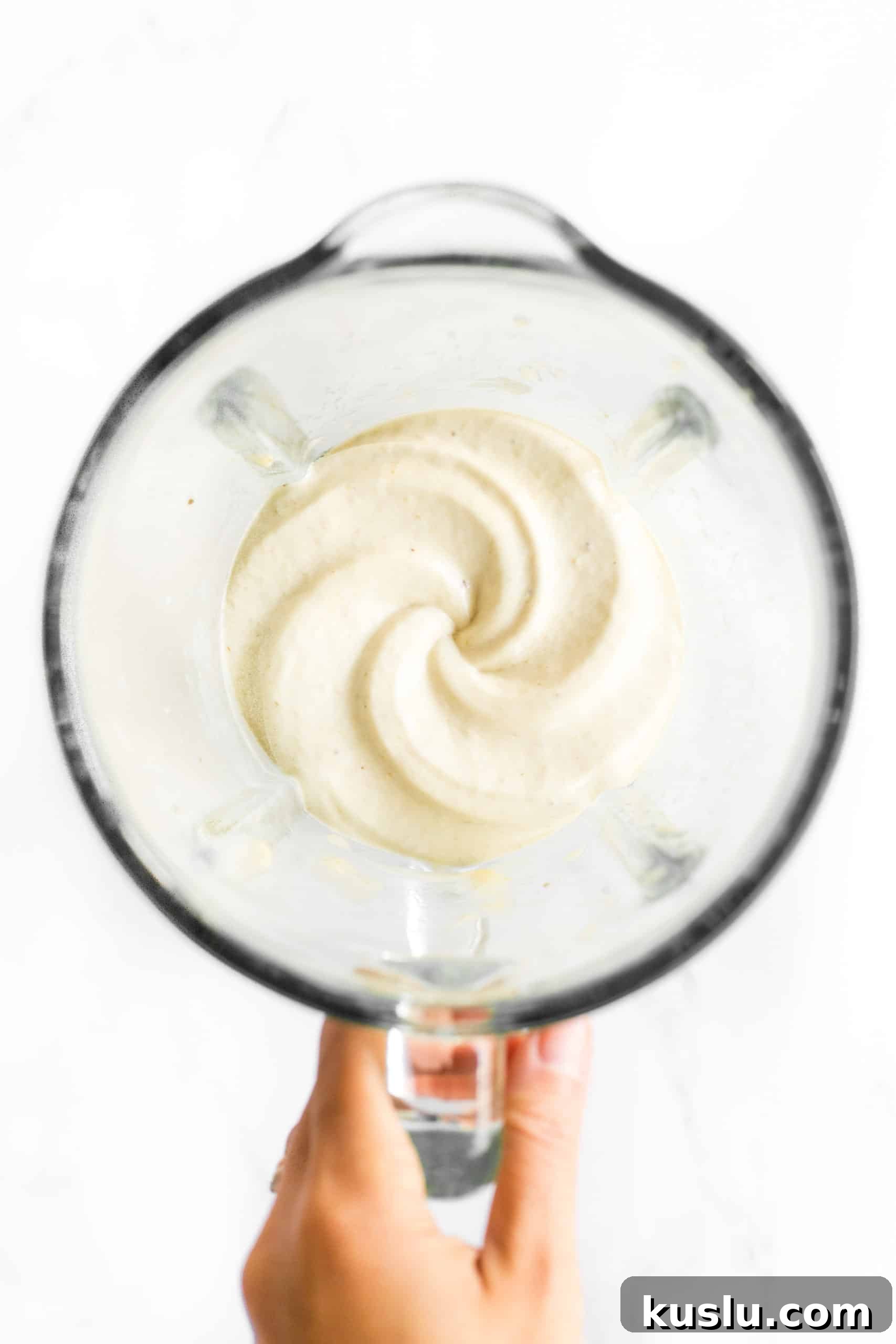 Freshly blended homemade banana ice cream in a high-speed blender.