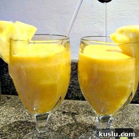 Creamy Tropical Smoothie. A lovely cool, refreshing drink using pineapple, mango, banana and strawberry. Quick and easy, perfect to start your morning off happy
