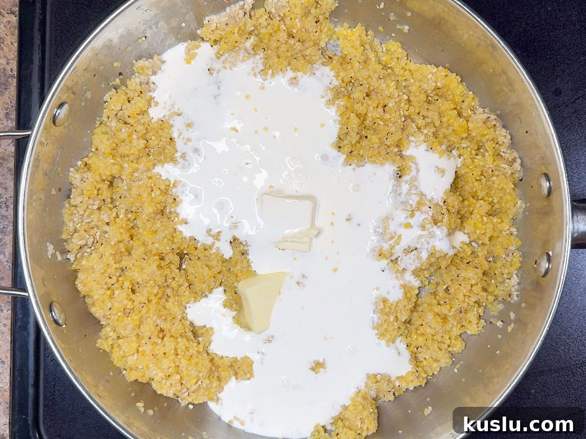 Southern Grillades and Grits Recipe: Classic New Orleans Comfort Food 13 Cooked grits in a large saucepan with butter and heavy cream added.