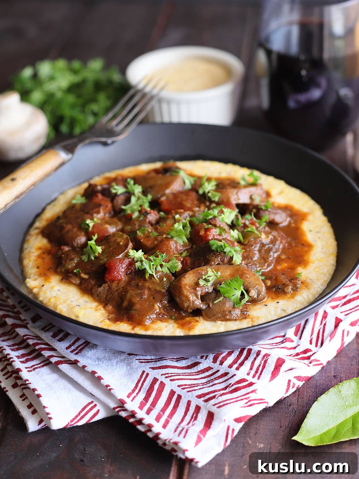 Southern Grillades and Grits Recipe: Classic New Orleans Comfort Food 14 Bowl of grillades and grits garnished with chopped fresh parsley.