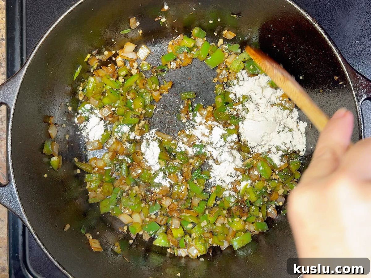 Southern Grillades and Grits Recipe: Classic New Orleans Comfort Food 8 Adding flour to the sauteed vegetables.