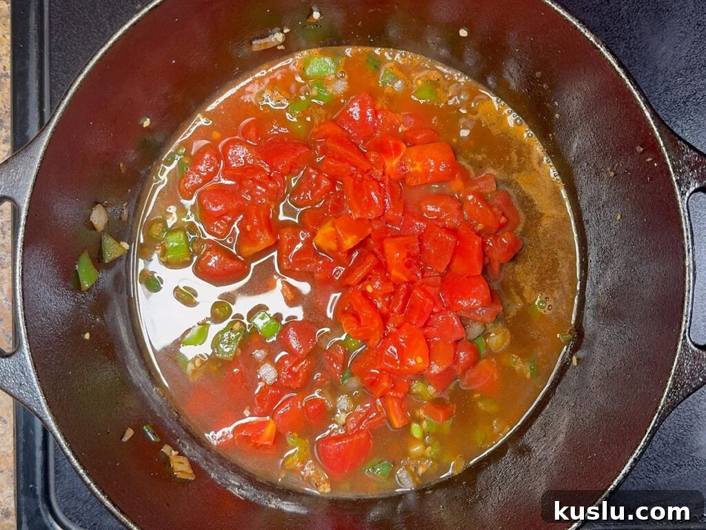 Southern Grillades and Grits Recipe: Classic New Orleans Comfort Food 9 Diced tomatoes and beef broth added to the Dutch oven with the sauteed vegetables.