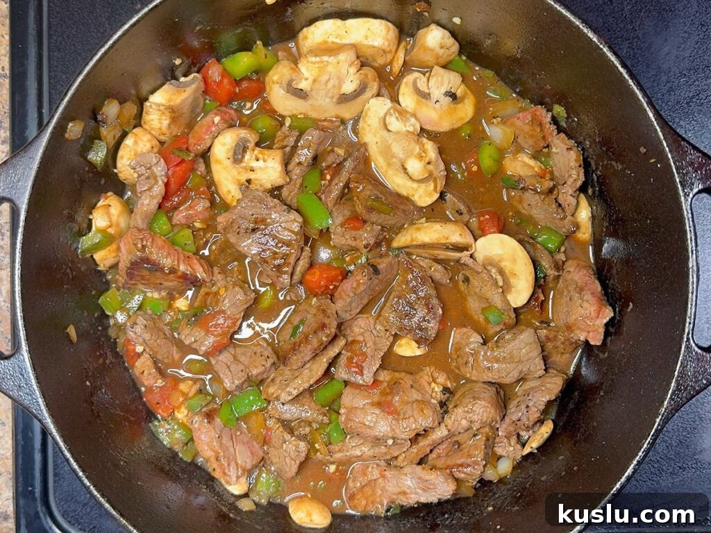 Southern Grillades and Grits Recipe: Classic New Orleans Comfort Food 10 Browned round steak and sliced mushrooms added back into the Dutch oven with the sauteed vegetables, tomatoes and broth.