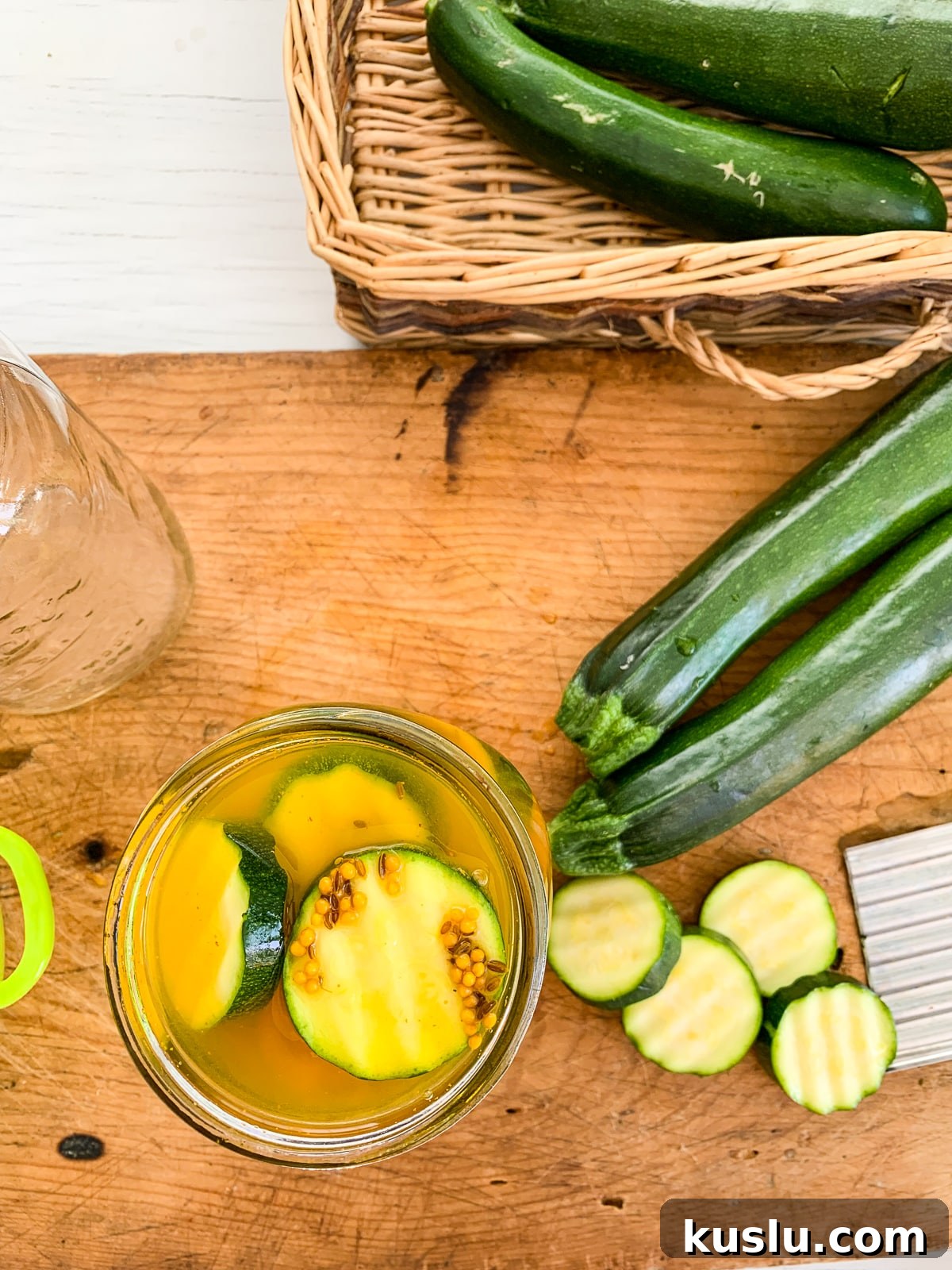 Quick Refrigerator Zucchini Pickles — No Canning Needed 11 Zucchini pickle chips packed in a jar
