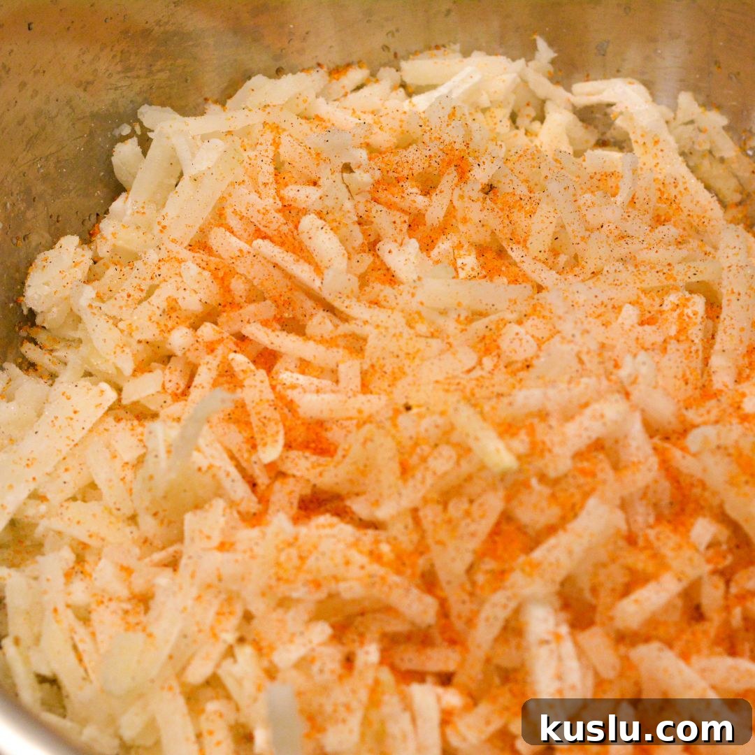 Start by thawing the frozen hash browns. Add the seasoning salt to the shredded potatoes or hash browns. 