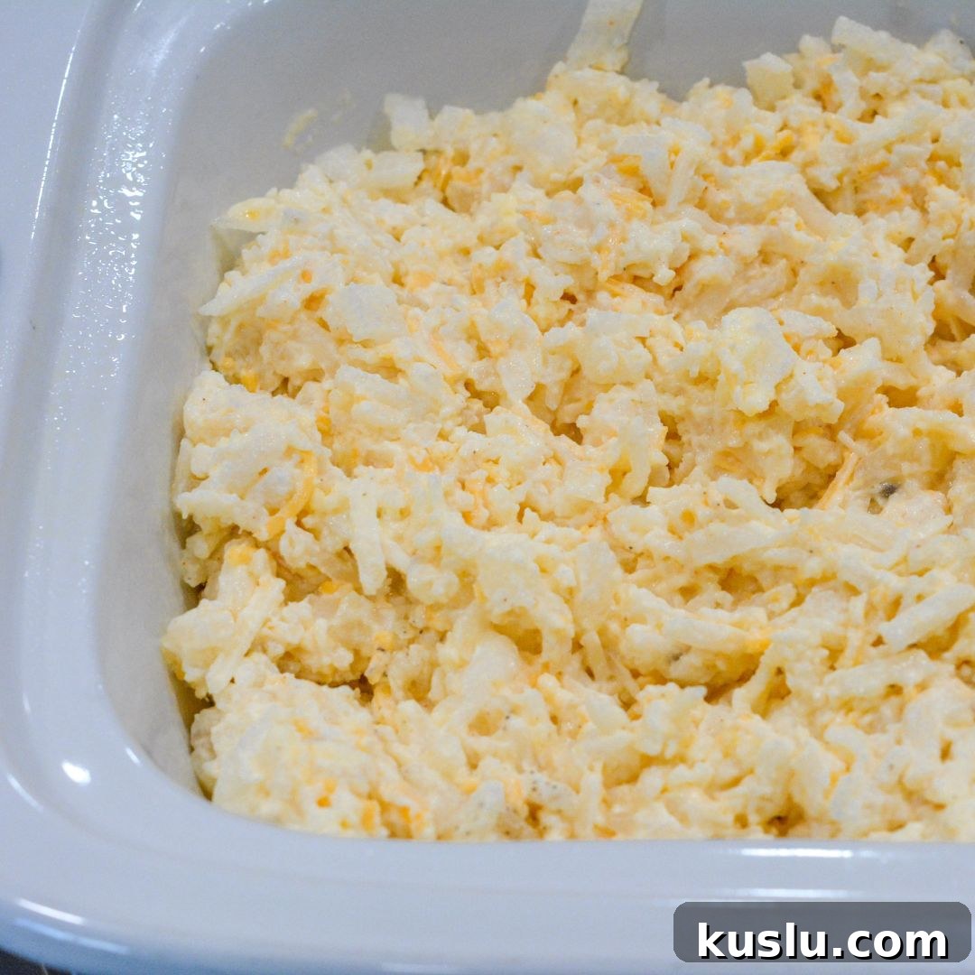 Cook in the Crock Pot: Grease the inside of your slow cooker with non-stick spray or butter. Pour the hash brown mixture into the crock pot and spread it out evenly.