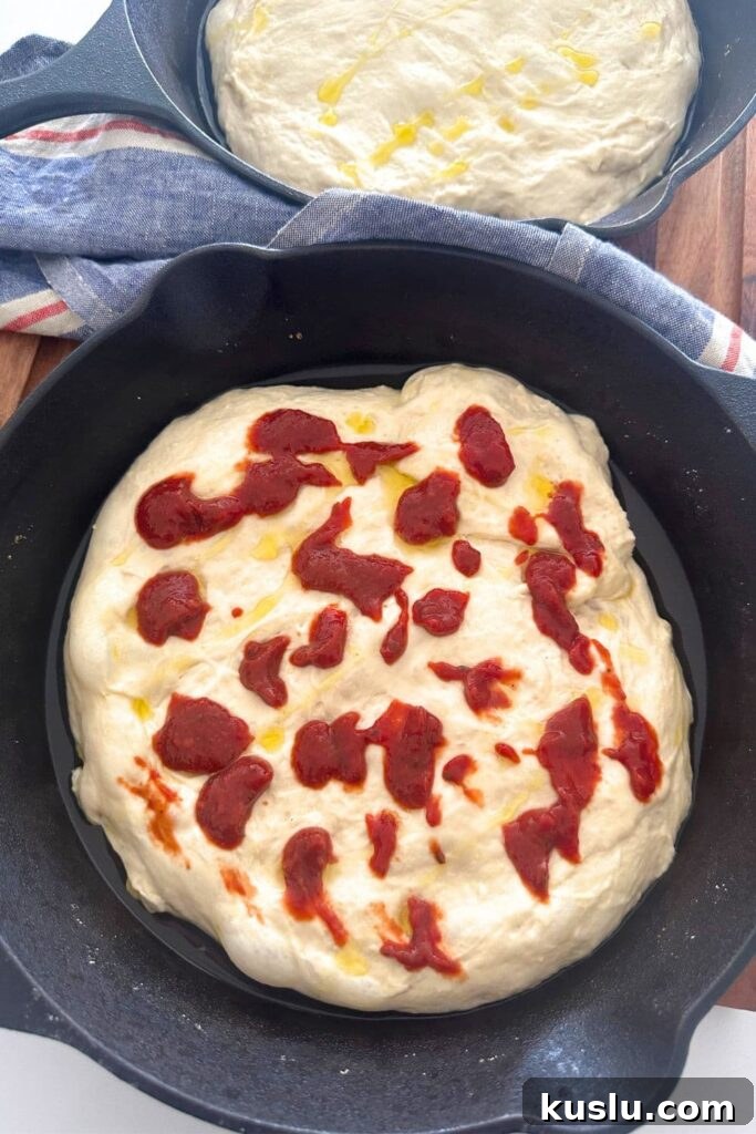 Dimpled focaccia with sauce and cheese