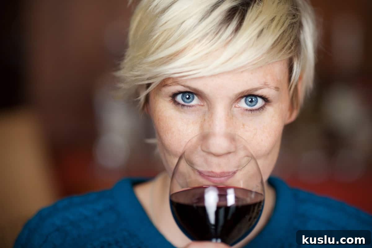 woman drinking red wine smiling