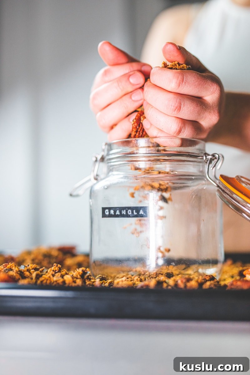 Putting the Maple Sea Salt Granola into a jar - Georgie Eats