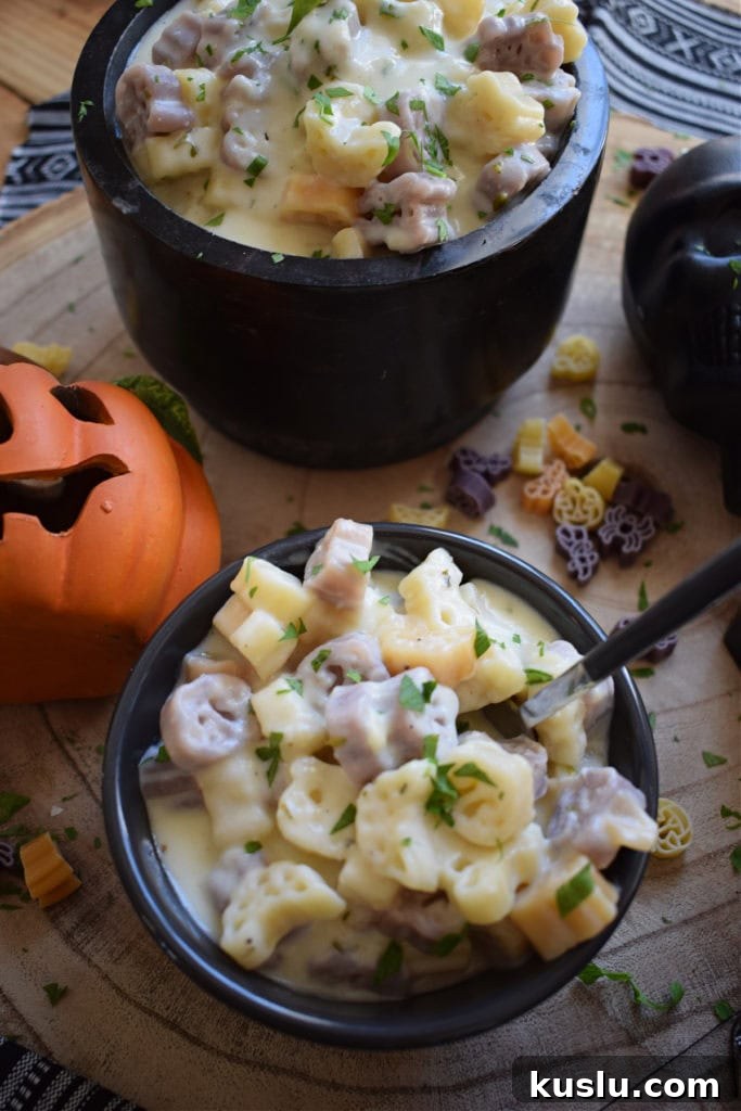halloween macaroni and cheese in black bowls with pumpkins