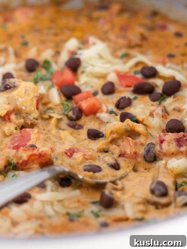 Pepperoni Pizza Football Cheese Ball Recipe: Game Day Appetizer 8 Velveeta queso in a skillet with toppings.
