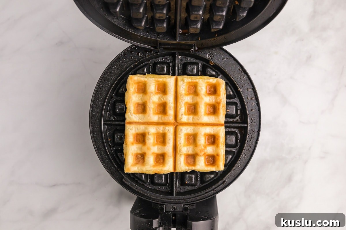 Cooked puff pastry on a waffle iron.