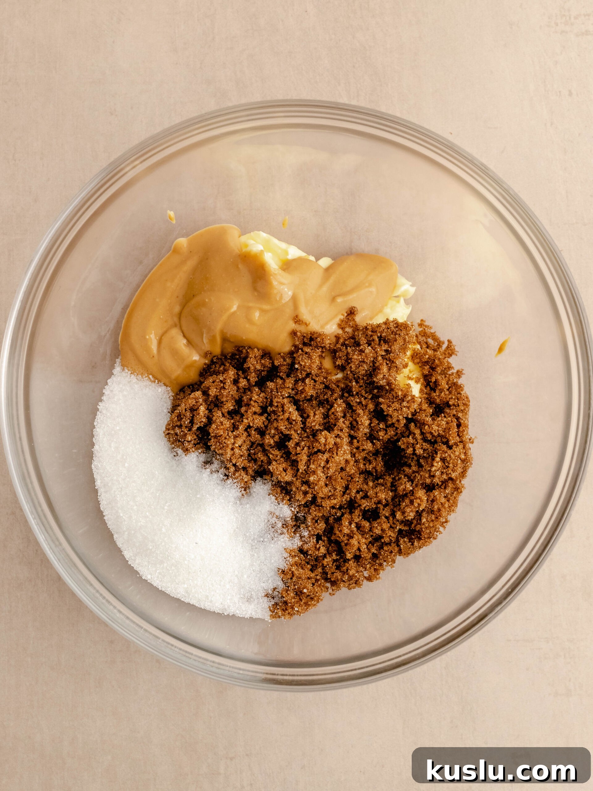 Brown sugar, granulated sugar, peanut butter and butter in a bowl.
