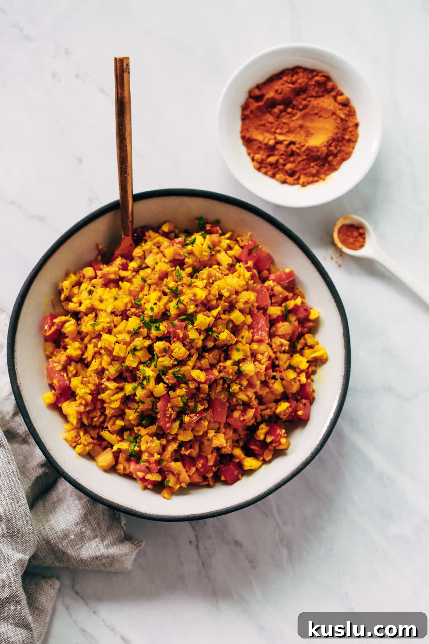 Overhead photo of a bowl of golden cauliflower rice.