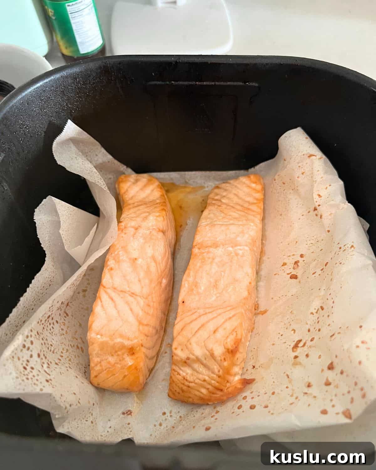 Salmon in air fryer basket. 
