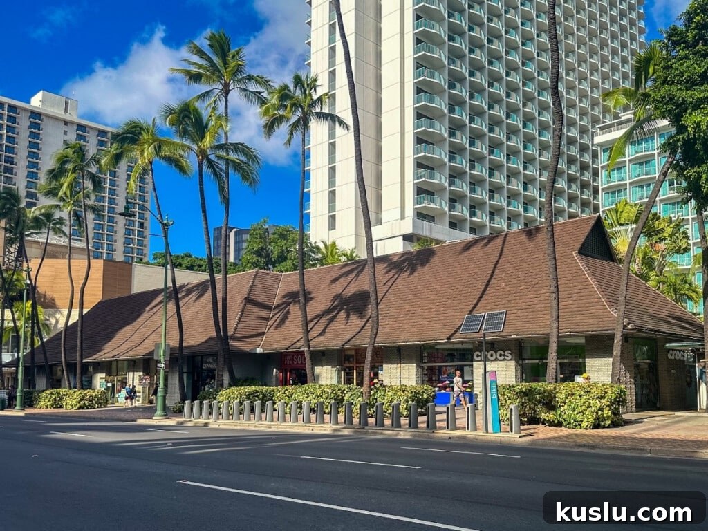 Shopping stores at Sheraton Princess Kaiulani in Waikīkī, featuring Crocs store, palm trees, and resort buildings. 