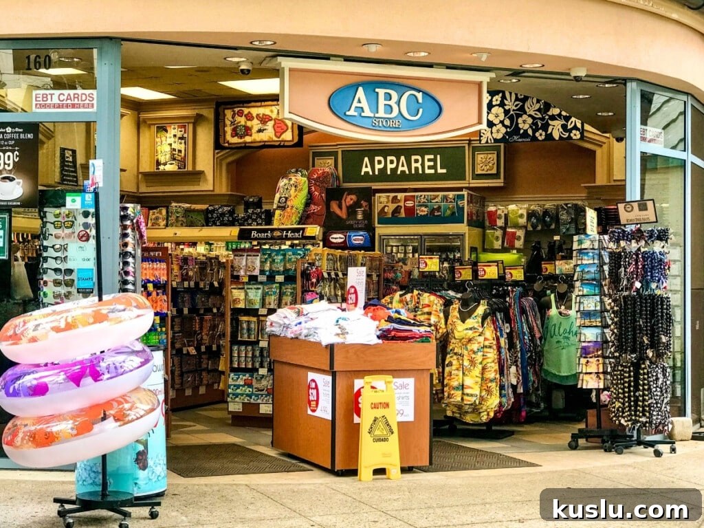 ABC Store in Waikiki showcasing colorful Hawaiian printed shirts, apparel, and inflatable swimming donuts in an open retail setting