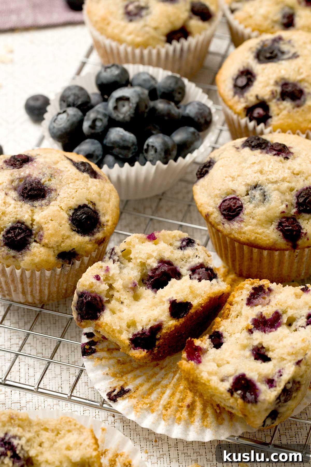 Blueberry cottage cheese muffins on a cooling rack with oat flour.