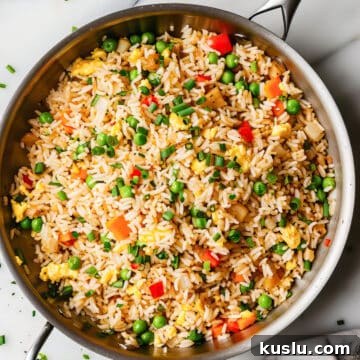 Easy egg-fried rice with vegetables in a skillet.