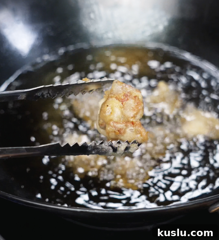 Crispy Korean Fried Chicken Recipe: How to Make Dakgangjeong 7 Fried chicken pieces are lowered back into the oil for a second fry at 400°F to get extra golden and crunchy.