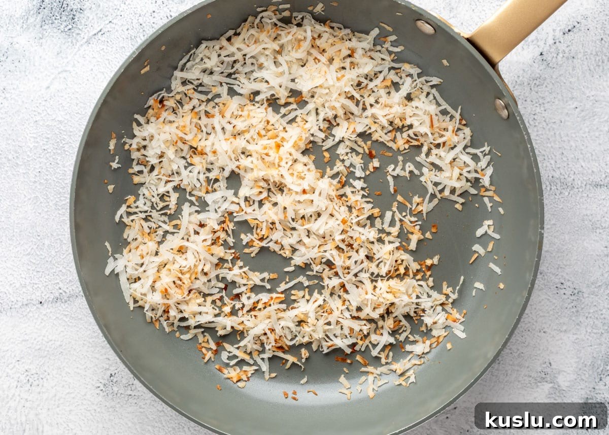 Coconut Pecan Rice Krispie Treats Recipe for Crispy Sweets 4 overhead of toasted coconut in a skillet