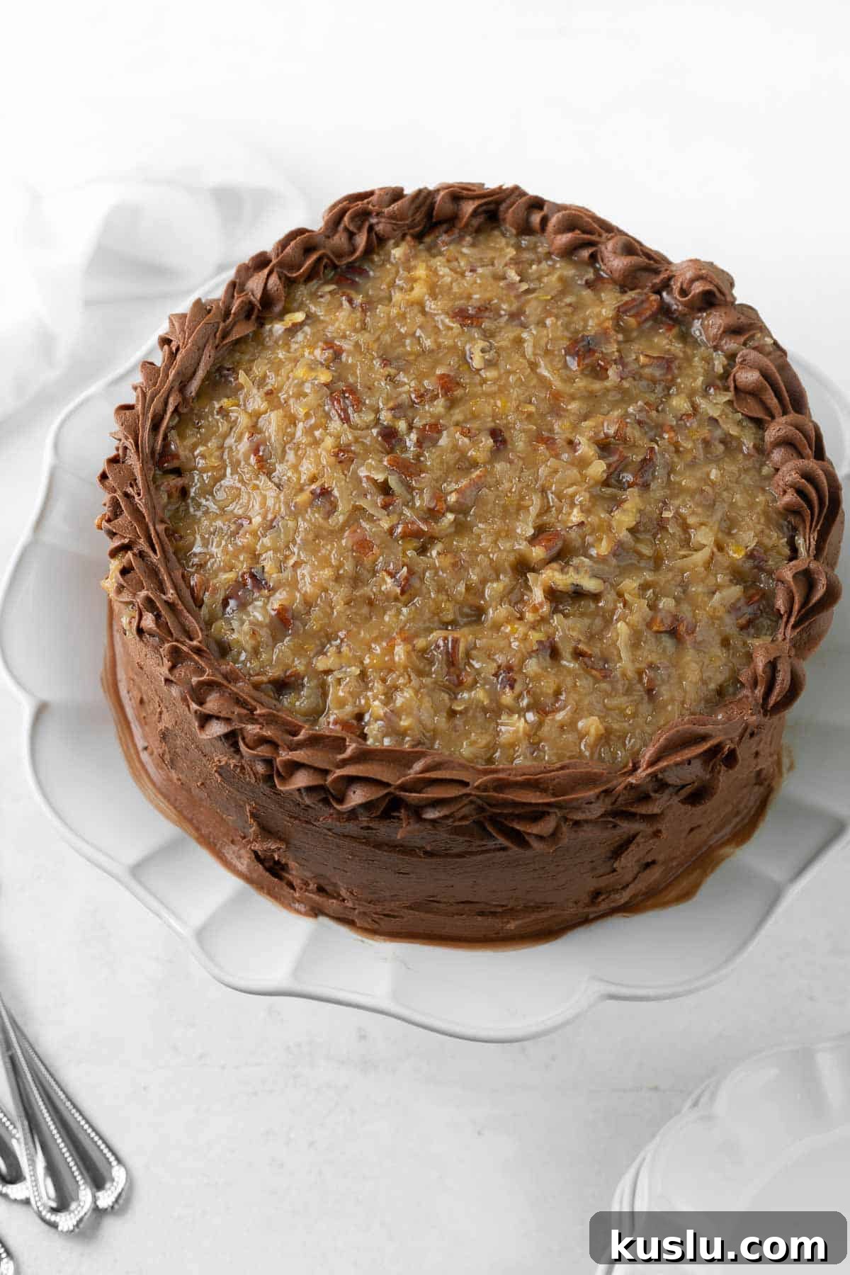 Gluten-Free German Chocolate Cake Recipe — Decadent & Moist 8 A whole German chocolate cake on a platter
