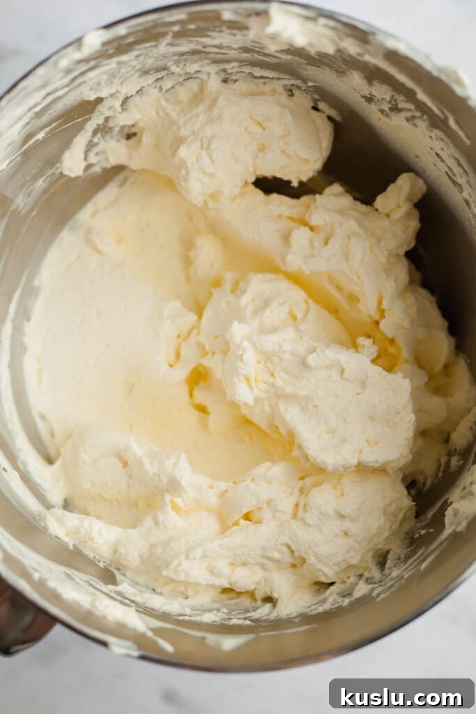 A silver bowl with cheesecake batter in it