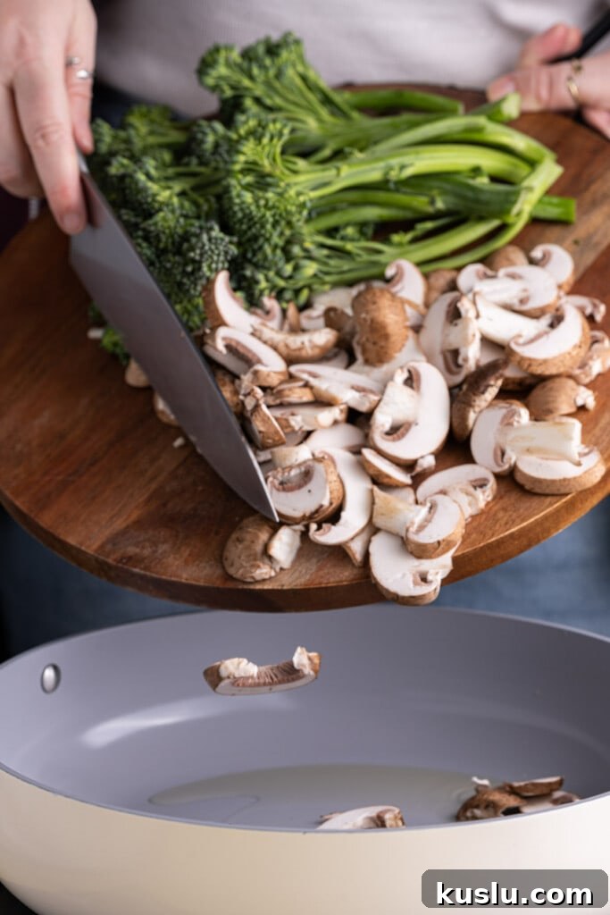 15-Minute Sautéed Broccolini with Garlic Mushrooms 9 Adding broccolini and mushrooms into a frying pan