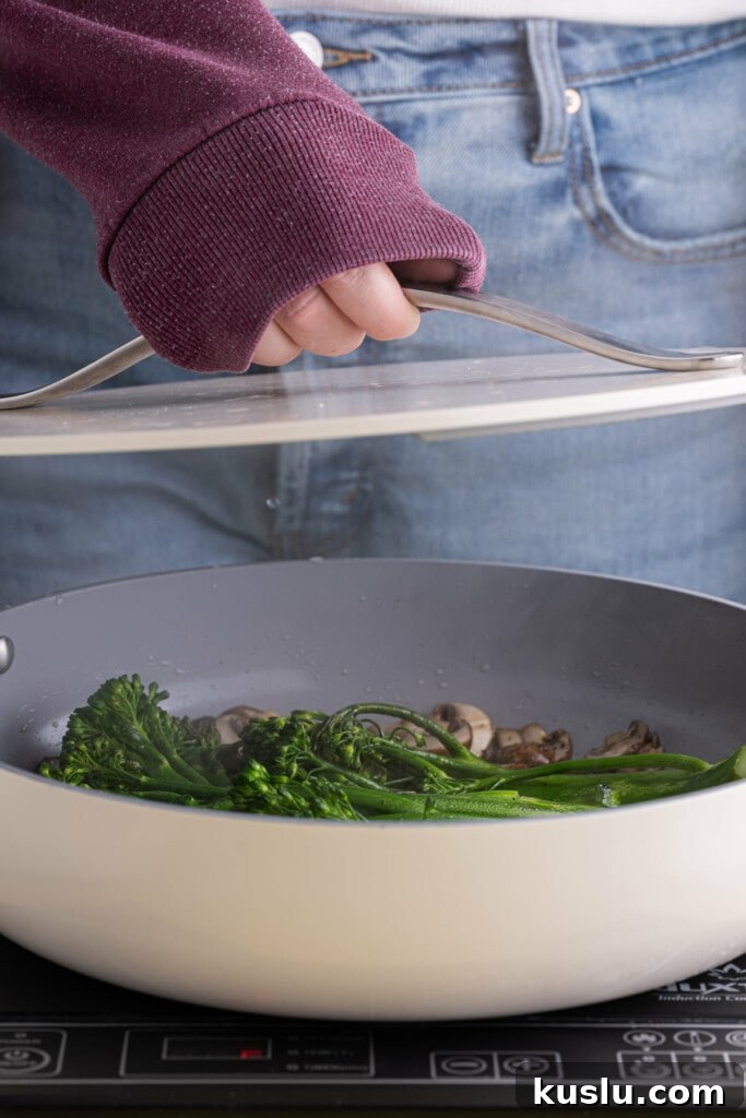 15-Minute Sautéed Broccolini with Garlic Mushrooms 10 Covering pan of mushrooms and broccolini