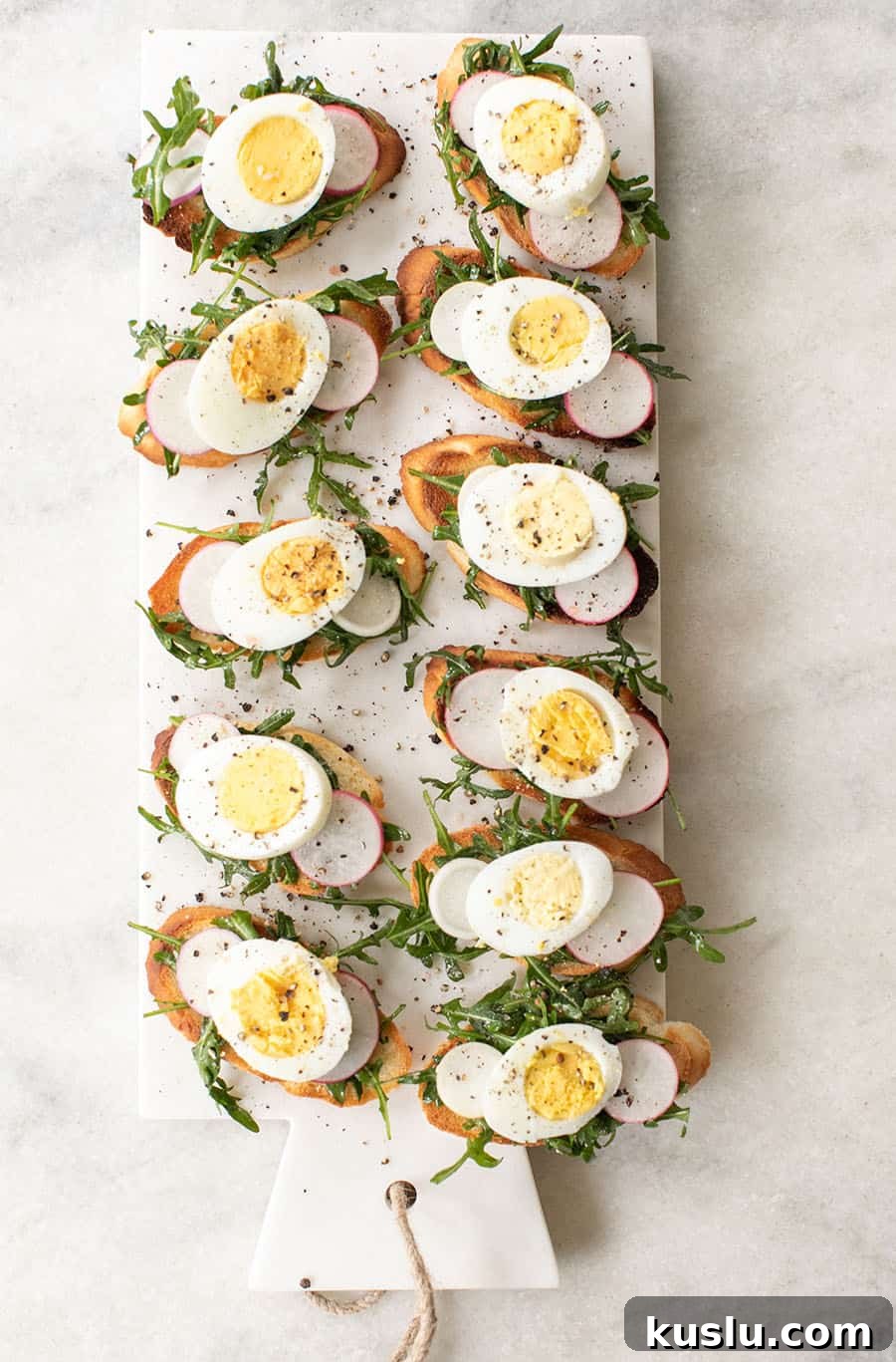 Crostini recipe with hard boiled eggs, arugula, salt and pepper.