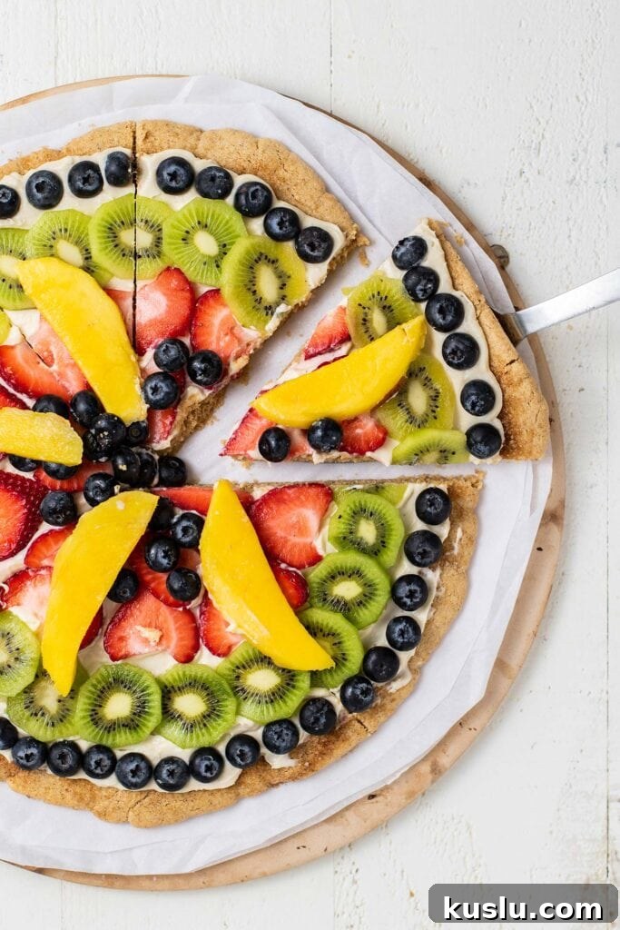 Fresh Fruit Pizza on a Crisp Cookie Crust: Summer Dessert Recipe 2 A snickerdoodle fruit pizza shown cut into slices.