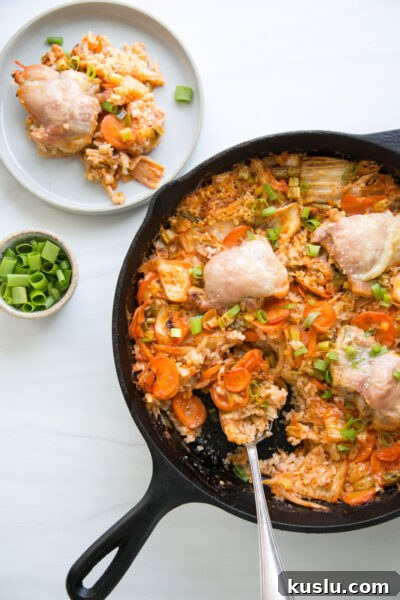 finished kimchi chicken casserole in a skillet with a spoon