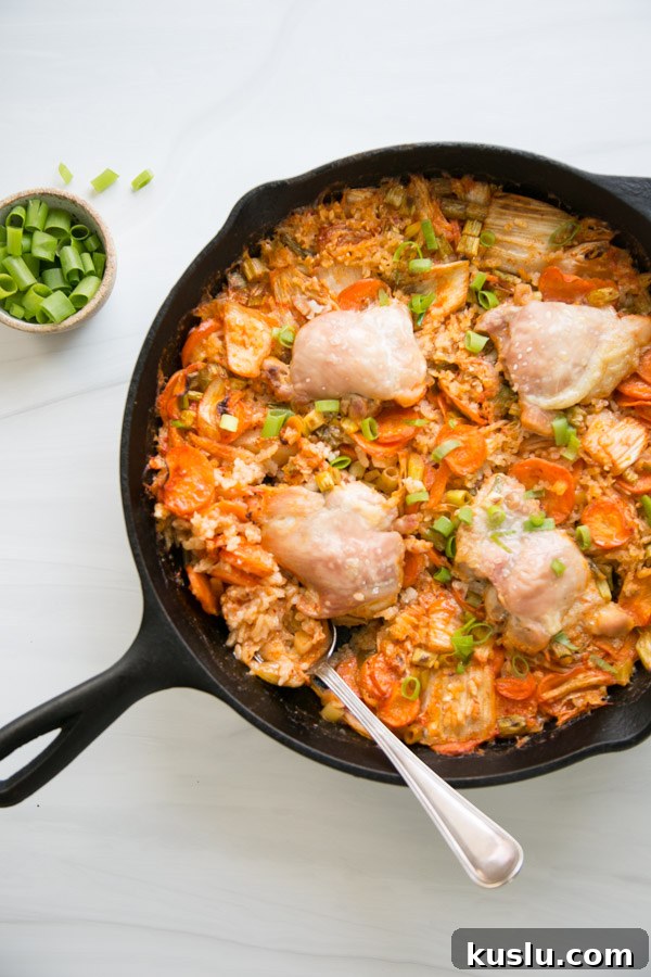 gluten-free chicken casserole in a skillet with a spoon