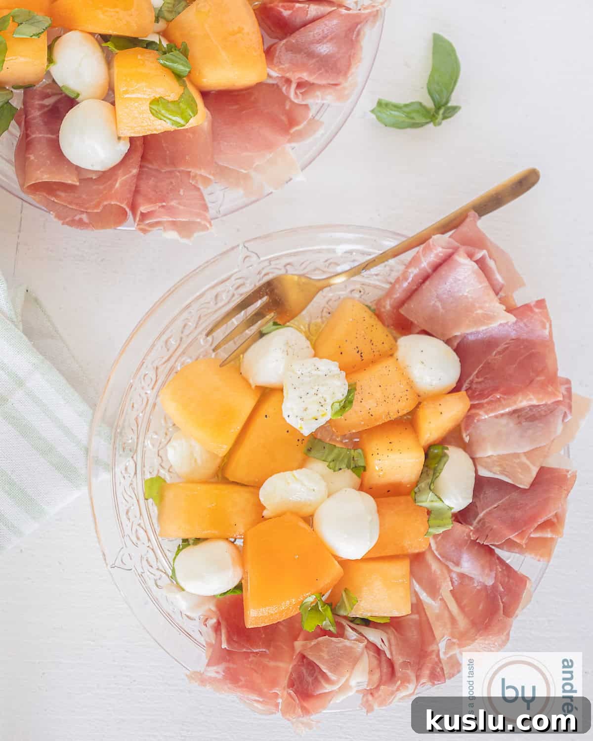A picture taken from above from a plate with ham, cantaloupe and mozzarella